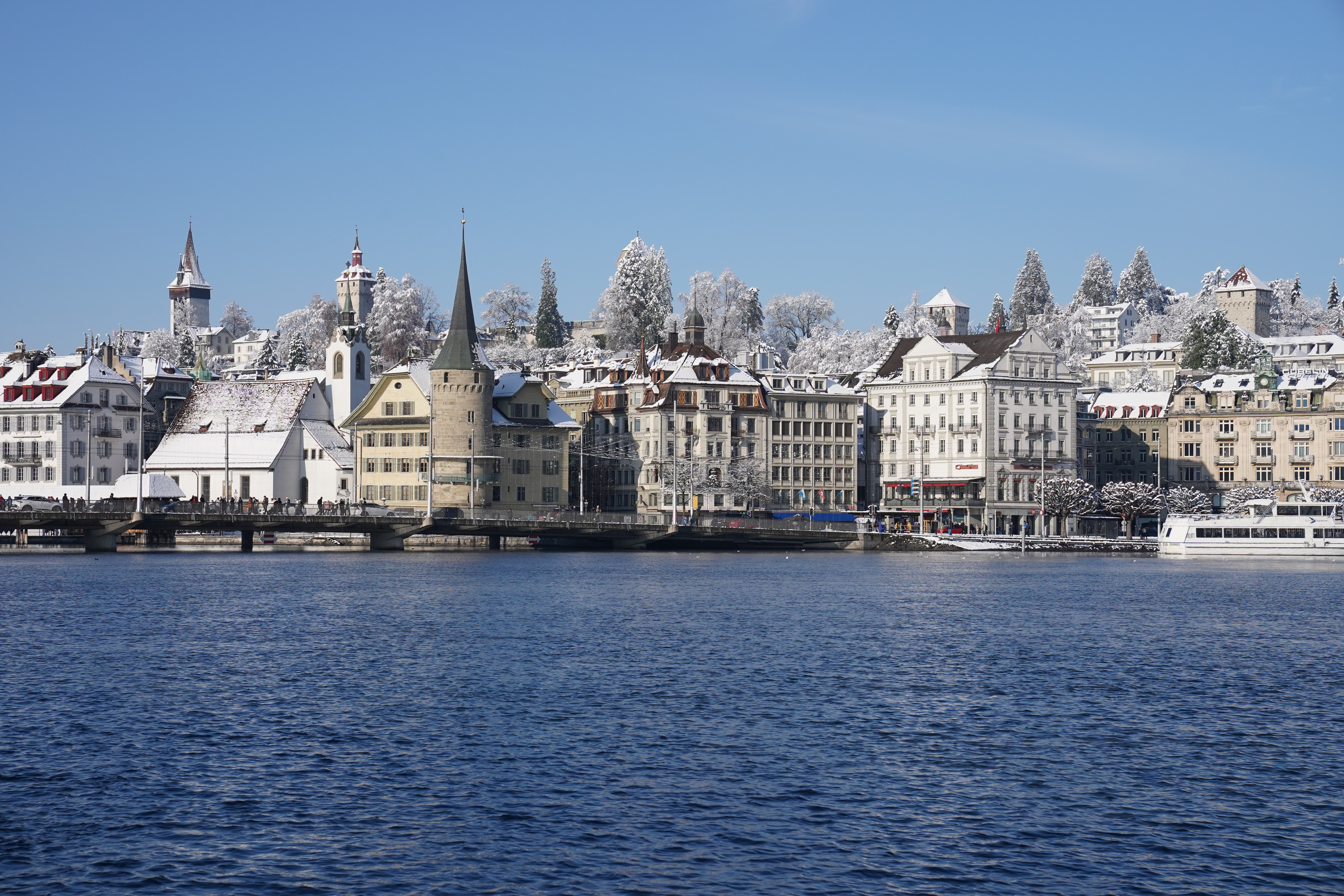 Lucerne old town waterfront in winter snow, Spreuer Bridge tower, Switzerland