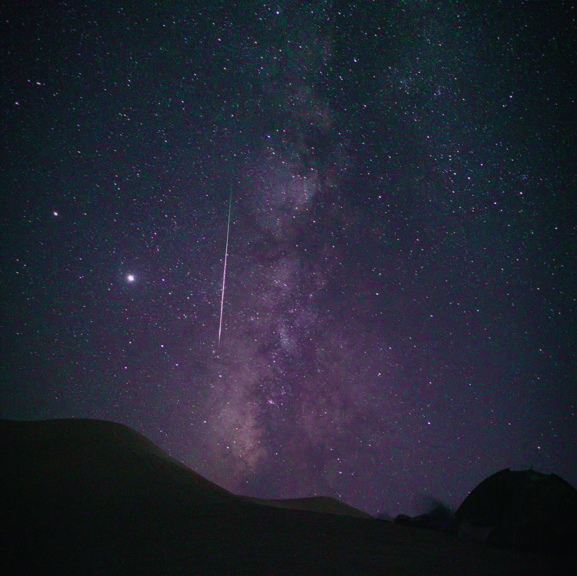 Milky Way over Dunhuang desert dunes, with a meteor streak